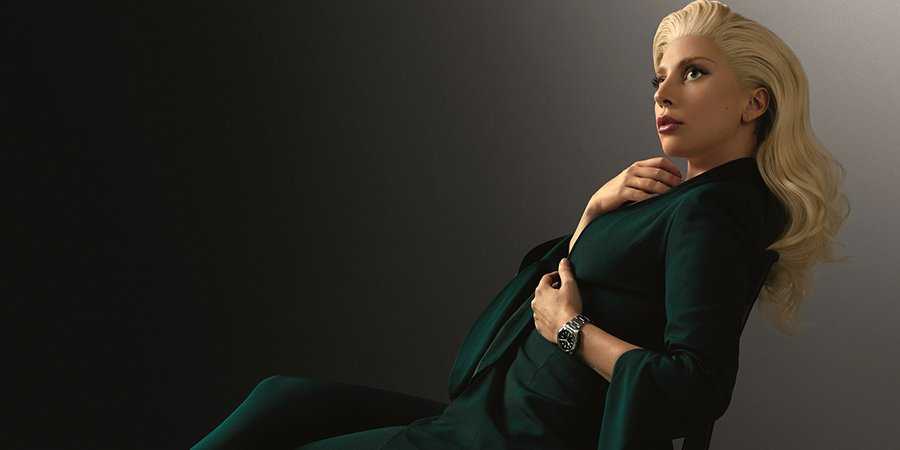 Lady Gaga wearing a green outfit and a TUDOR watch