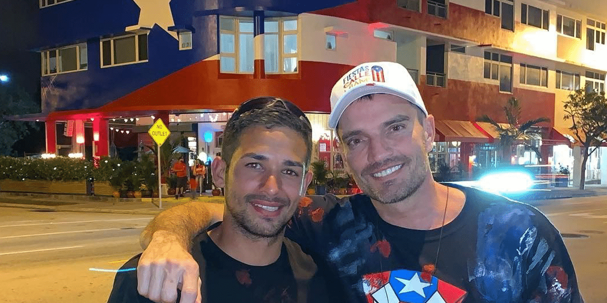 Julian Gil and Hector Collazo in front of the Mural of the Puerto Rican flag in La Placita.